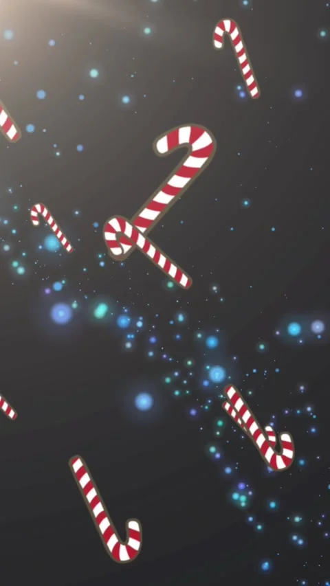 Multiple candy cane icons falling against blue spots of light on black Stock Footage 343954956