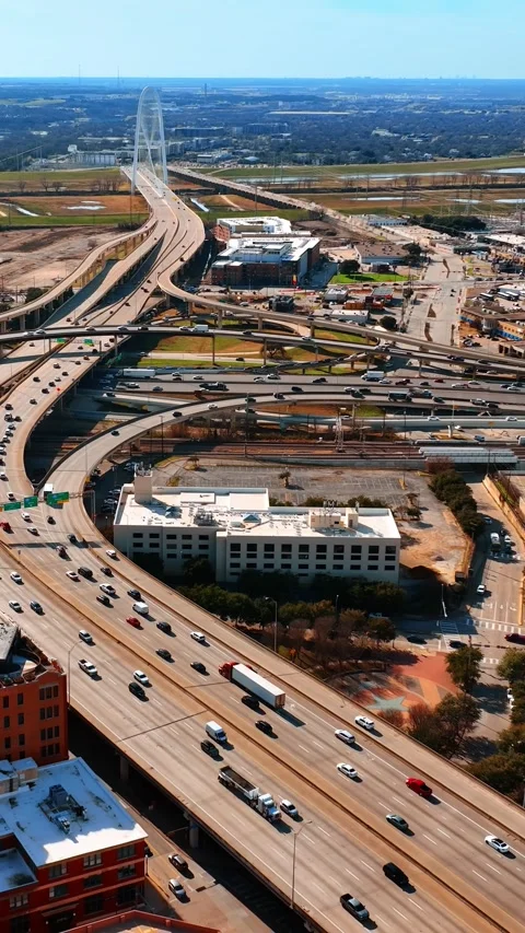 Multiple cars run by the roads and freeways at daytime. Traffic system of Dallas Stock Footage 332345849