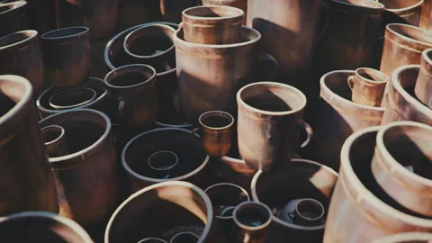 Multiple ceramic handmade clay pots timelapse with moving shadow. Pottery shop Stock Footage 256070849