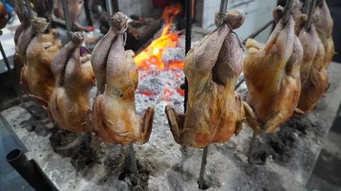 Multiple Chickens Chargha Grilling Over Charcoal at a Street Shop 写真素材