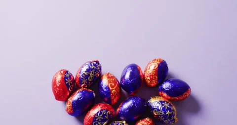 Multiple chocolate easter eggs on purple background with copy space Stock Footage 331246015