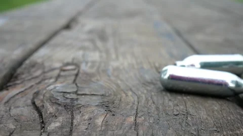 Multiple chrome nitrous oxide laughing gas drug cylinders Stock Footage 133363861