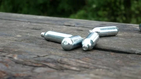 Multiple chrome nitrous oxide laughing gas drug cylinders Stock Footage 133363900