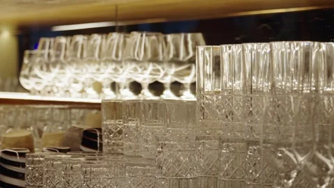 Multiple clean glasses stacked on bar counter. Night club bar Stock Footage 304315538