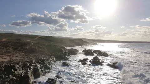 Multiple clips of a cliff at sunset with waves Video stock 94508578