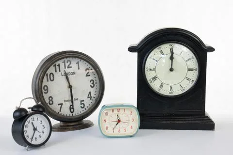 Multiple clocks isolated on a white background Stock Photos