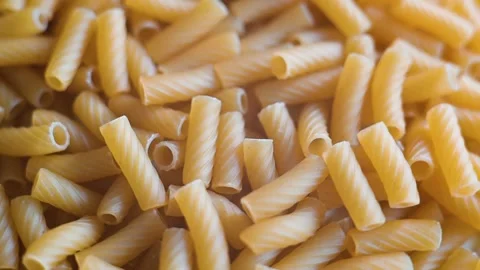 Multiple close-up views show uncooked pasta pieces arranged in an orderly manner Stock-Footage 338290439