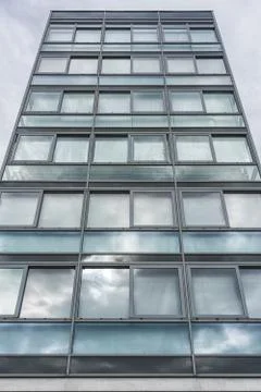 Multiple closed windows on a large office building Stock Photos