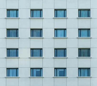 Multiple closed windows on a large office building Stock Photos