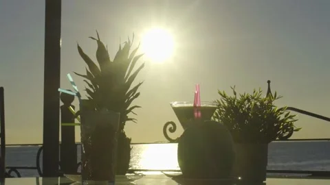 Multiple cocktails on a table with sun setting in the background Stock Footage 140053879