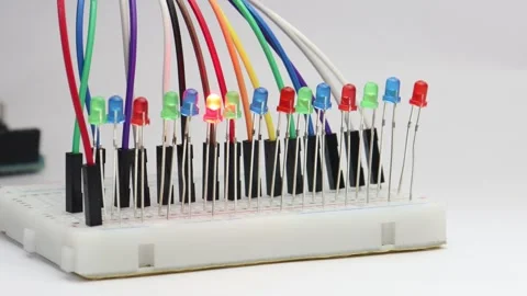 Multiple color LED or the light emitting diodes are arranged in breadboard Stock Footage 339018349
