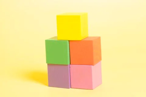 Multiple colored cubes on yellow background Stock Photos