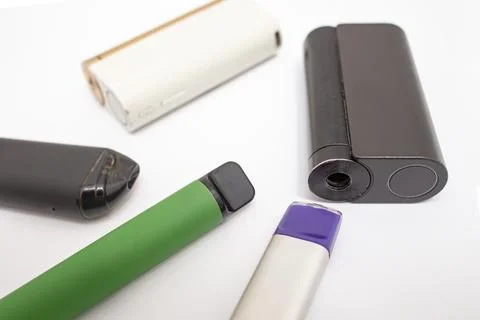 Multiple colored electronic cigarettes pile, isolated on white background Stock Photos