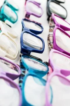 Multiple colored eye glasses and lined on white background. Eye Health Concep Stock Photos
