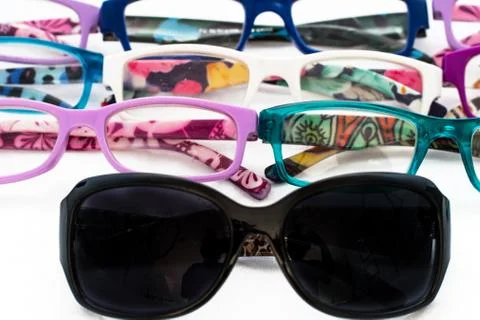 Multiple colored eye glasses and sunglasses on white background. Eye Health C Stock Photos