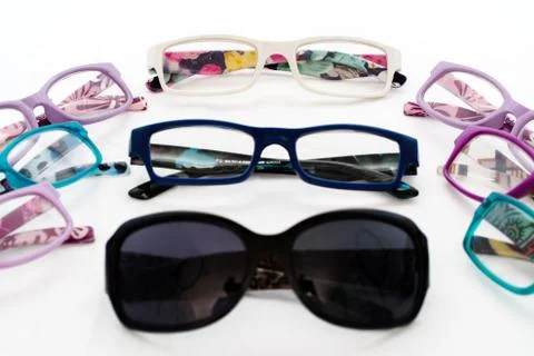Multiple colored eye glasses and sunglasses on white background. Eye Health C Foto stock