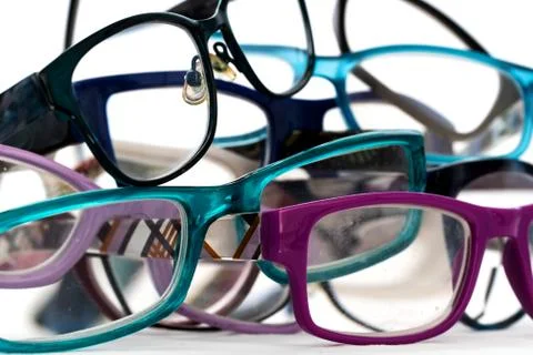 Multiple colored eye glasses in a pile on white background. Eye Health Concep Stock Photos