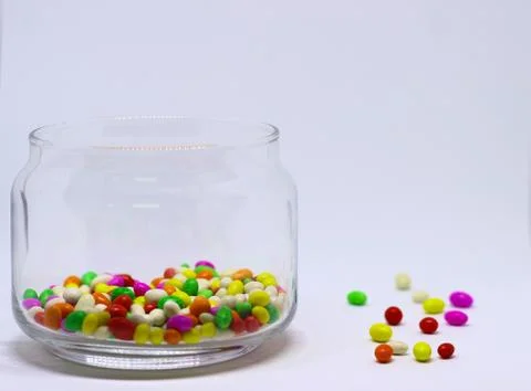 Multiple colored Sugar Candy In Glass Container in White Background Stock Photos