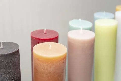 Multiple colored thick candles, on gray background Foto stock