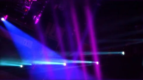 Multiple colorful turned on stage lights mounted to ceiling flashing in Stockbeeldmateriaal 123554819