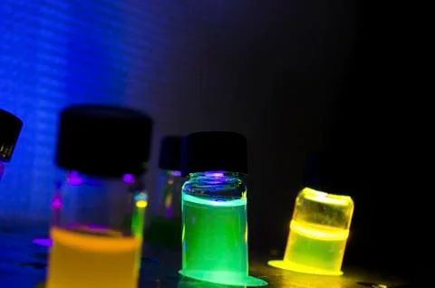 Multiple colourful close up light induced photochemical reaction in glass via Stock Photos