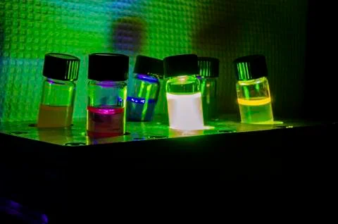 Multiple colourful light induced catalyst photochemical reaction side view in Stock Photos