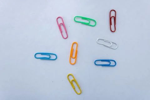 Multiple Colourful paperclips isolated on white background and shot from th.. Stock Photos