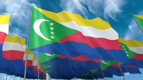 Multiple Comoros flags seamless looping waving on blue sky Stock Footage 343678255