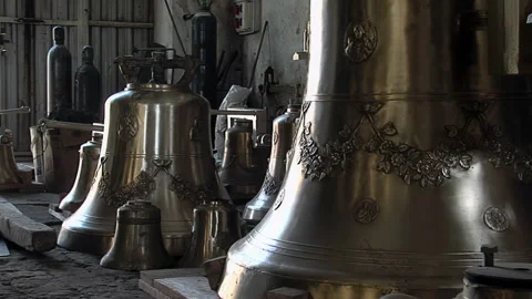 Multiple Completed Bronze Bells Inside Traditional Church Bell Foundry - 4K Stock Footage 339692836