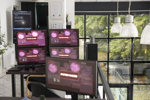 Multiple computer monitors in vacant office display warning messages Stock-Fotos