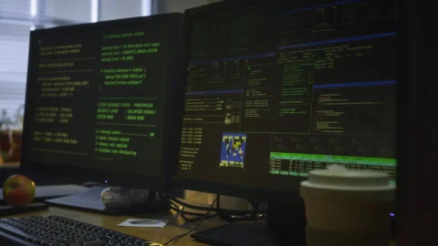 Multiple Computer Screens Running Codes on Cybercriminal Desk at Night Video stock 328243349