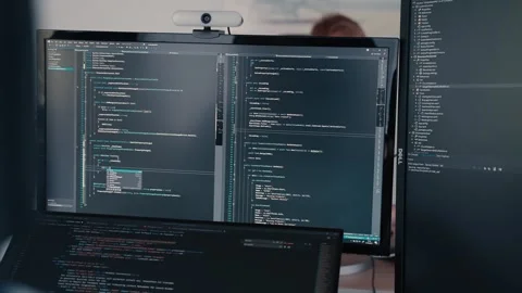 Multiple computer screens showing coding work of softwares what could be 스톡 동영상 263806923