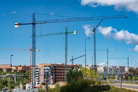 Multiple construction cranes to build homes in new areas of expansion, Madrid Stock Photos