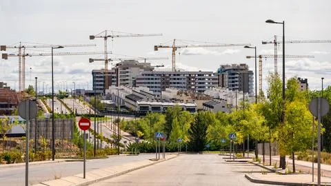 Multiple construction cranes to build homes in new areas of expansion, Madrid Stock Photos