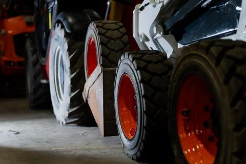 Multiple construction vehicles positioned in storage area Stock Photos
