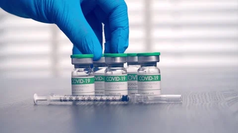 Multiple COVID-19 vaccine vials placed on a laboratory table Stock Footage 153068367