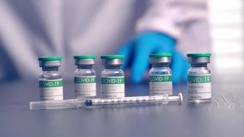 Multiple COVID-19 vaccine vials placed on a laboratory table Stock Footage 153068427