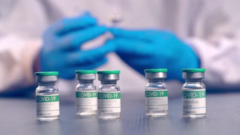 Multiple COVID-19 vaccine vials placed on a laboratory table Stock Footage 153068459
