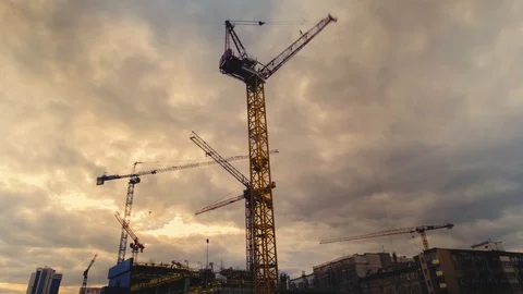 Multiple cranes silhouettes moving at construction site Stock Footage 95934184