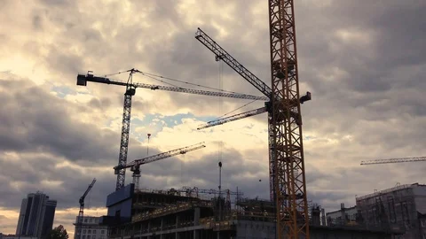 Multiple cranes silhouettes moving at construction site Stock Footage 95934208