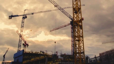 Multiple cranes silhouettes moving at construction site Stock Footage 95934486