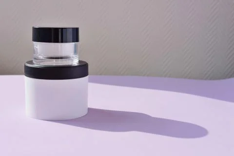 Multiple cream jars. two bottles for cream or scrub or oil on a colorful back Stock Photos