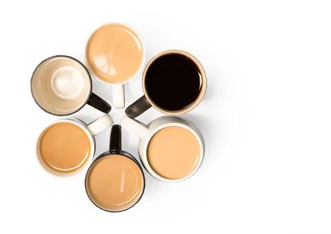 Multiple cups of coffee placed in flower shape on white background, morning and Stock Photos