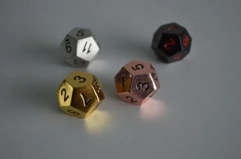 Multiple d12 twelve sided dice die copper silver gold black Foto stock