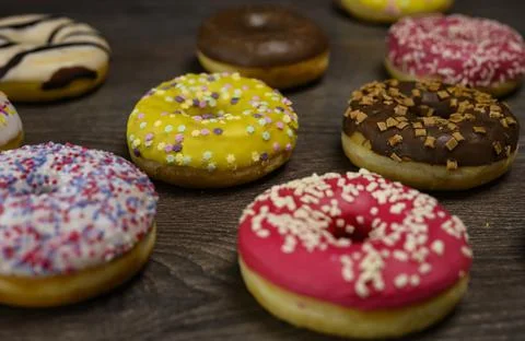 Multiple delicious donuts on table close up shot Stock Photos