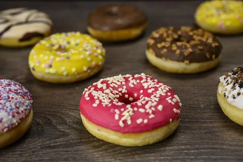 Multiple delicious donuts on table close up shot Stock Photos