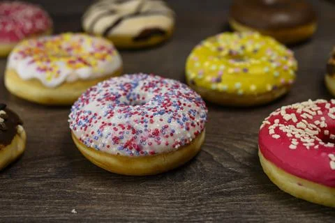 Multiple delicious donuts on table close up shot Stock Photos