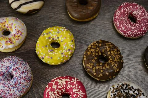 Multiple delicious donuts on table close up shot Stock Photos