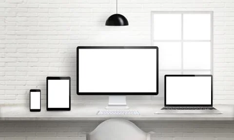 Multiple devices on office desk for responsive web site design presentation.  Stock Photos