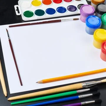 Multiple drawing paints and brushes Stock Photos